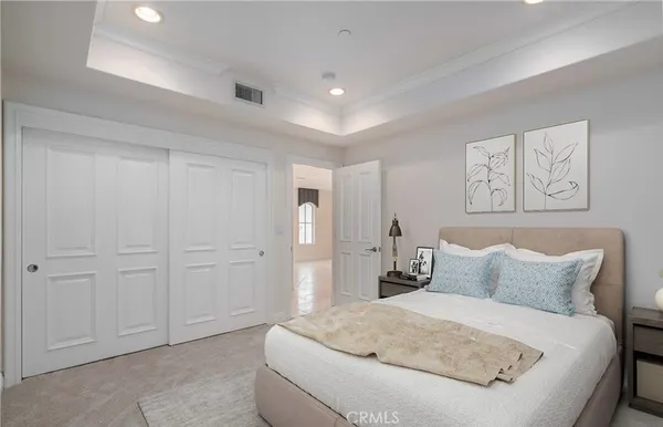 a bedroom with a bed and painting on the wall