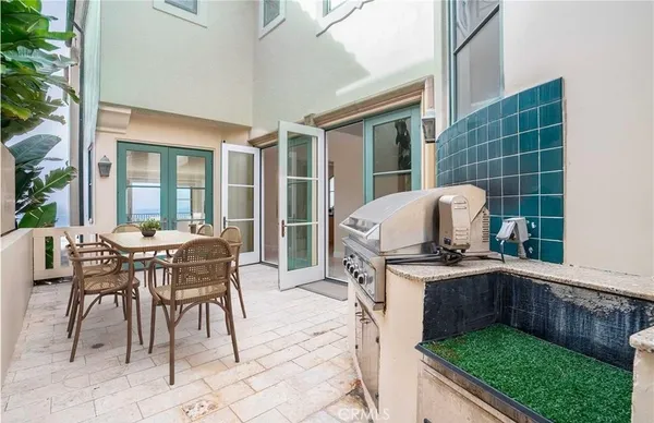 a view of a kitchen with stainless steel appliances granite countertop a refrigerator and a stove