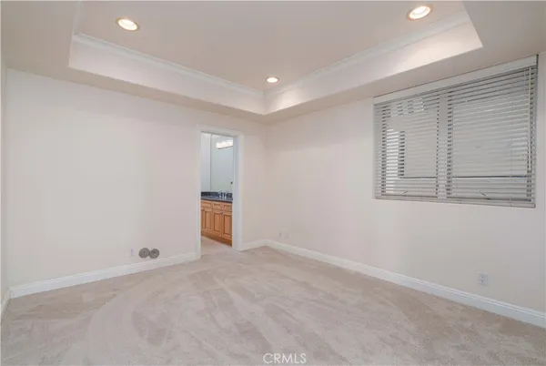an empty room with sliding glass door and a window