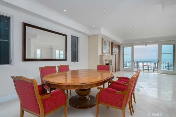 a view of a dining room with furniture and a large window
