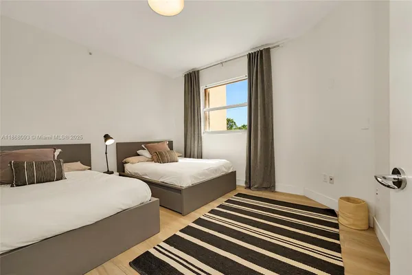 a bedroom with two beds and painted walls