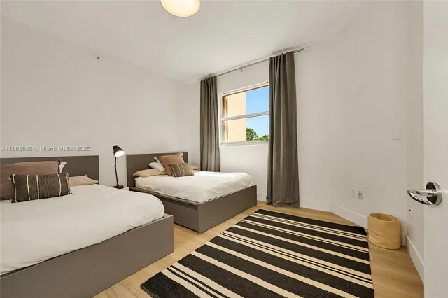 a bedroom with two beds and painted walls