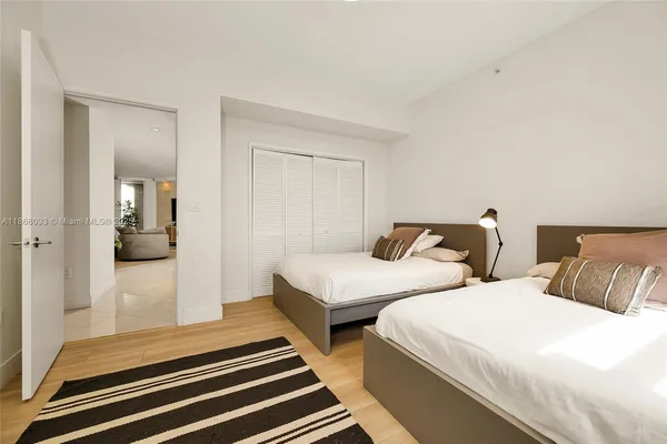 a bedroom with two beds and painted walls