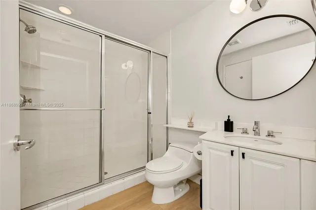 a bathroom with a toilet a sink and a mirror