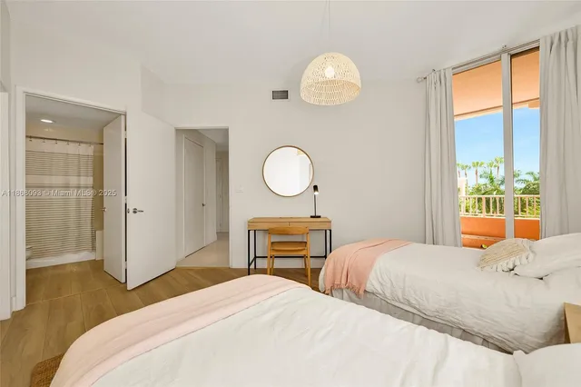 a bedroom with a bed and dresser with mirror