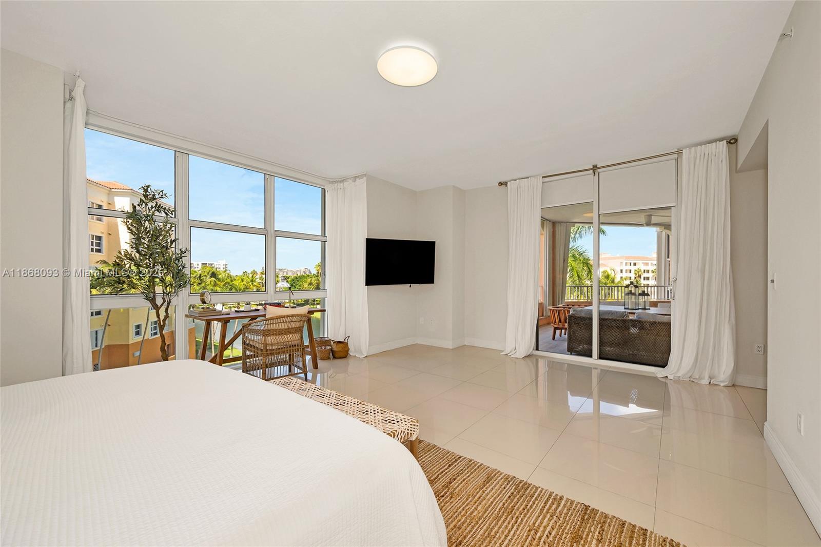 Village of Key Biscayne Key Biscayne, FL 33149 - Photo 20 of 24 a bedroom with a bed and a potted plant