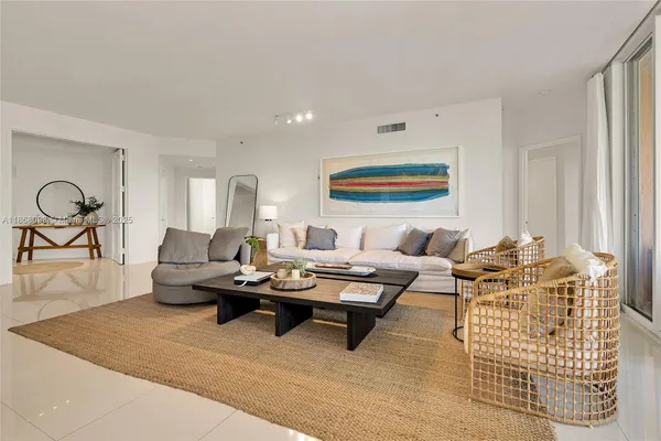 a living room with furniture a rug and a painting on the wall