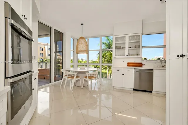 a kitchen with a stove a refrigerator and a dining table