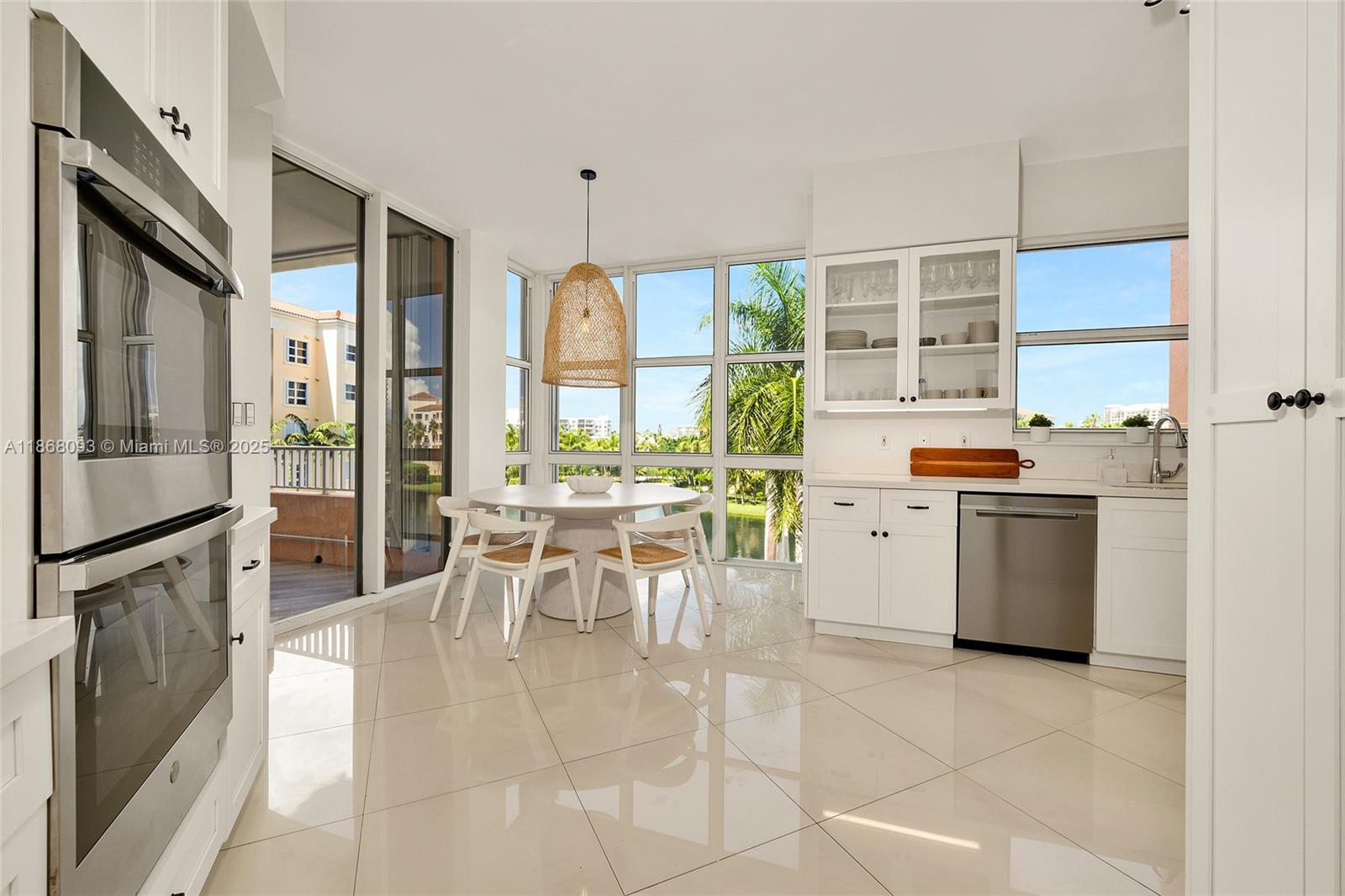 Village of Key Biscayne Key Biscayne, FL 33149 - Photo 6 of 24 a kitchen with a stove a refrigerator and a dining table