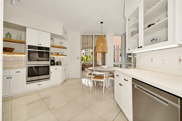 a kitchen with stainless steel appliances a stove a sink and a refrigerator