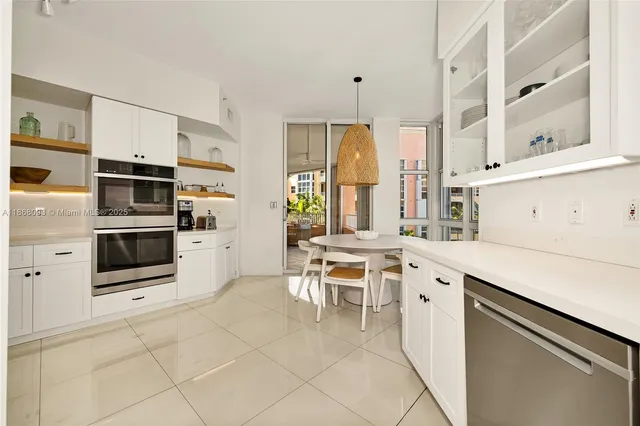 a kitchen with stainless steel appliances a stove a sink and a refrigerator