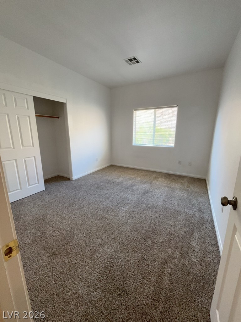4915 East Russell Road, Unit 143 Las Vegas, NV 89120 - Photo 7 of 10 An inviting room features plush carpeting and a convenient sliding closet.