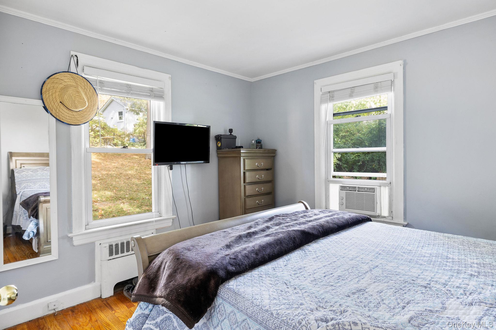 2 Tuxedo Road Carmel, NY 10512 - Photo 12 of 25 a bedroom with a bed and a flat tv screen on dresser