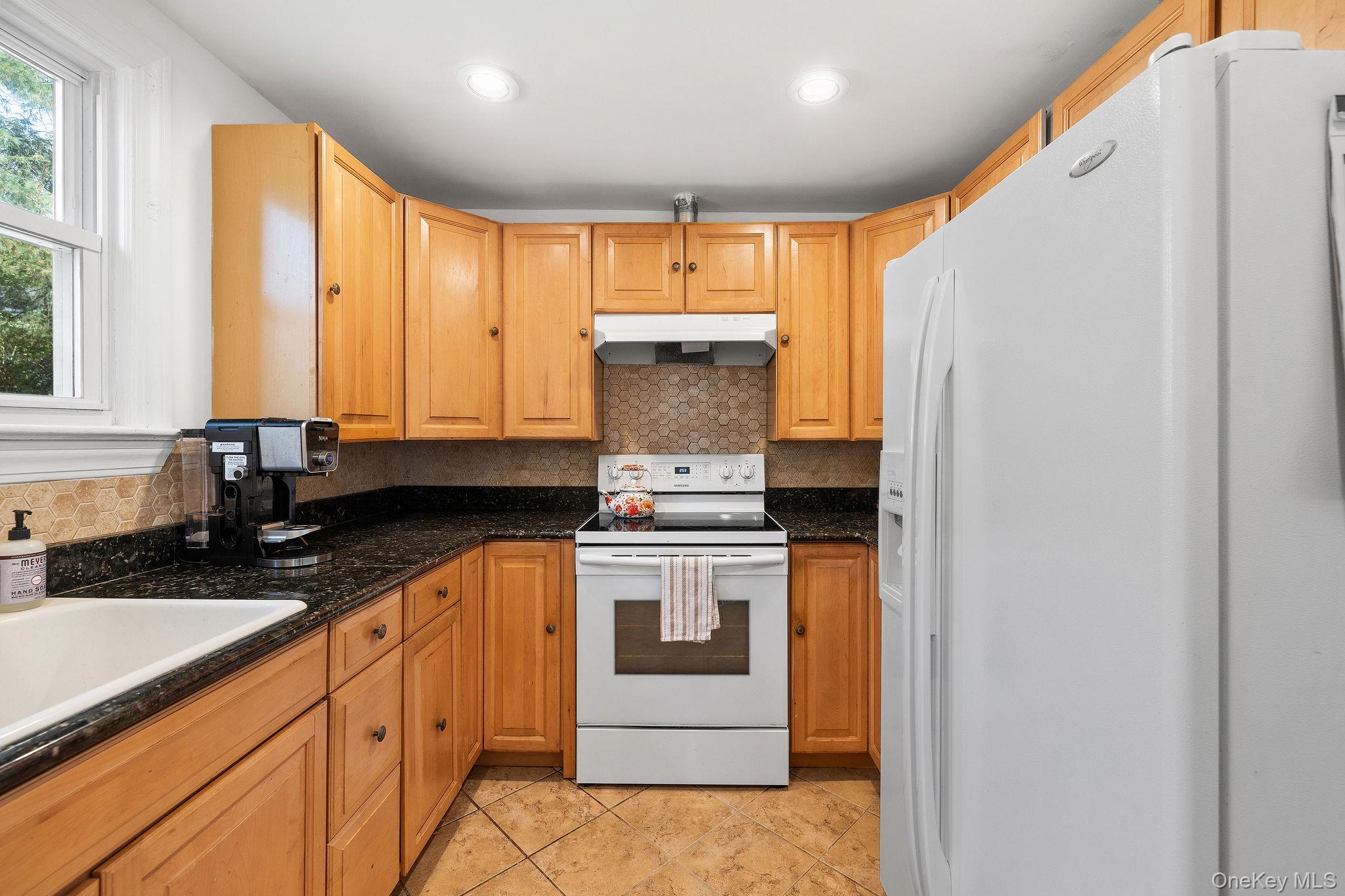2 Tuxedo Road Carmel, NY 10512 - Photo 17 of 25 a kitchen with stainless steel appliances granite countertop a stove and a refrigerator