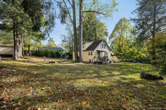 a view of house with backyard and tree