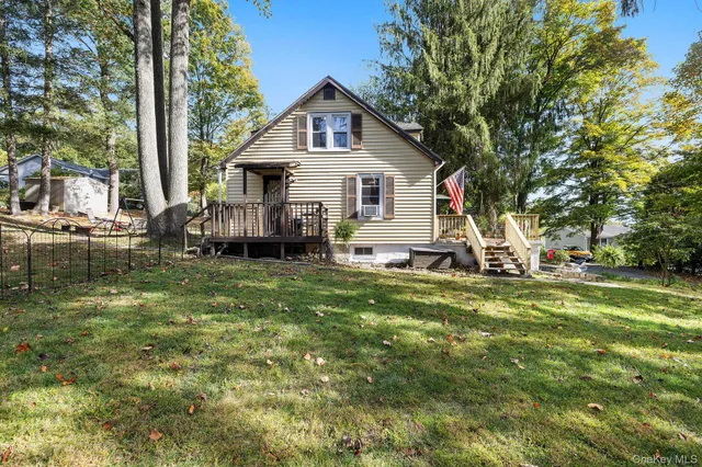 a front view of a house with a yard table and chairs