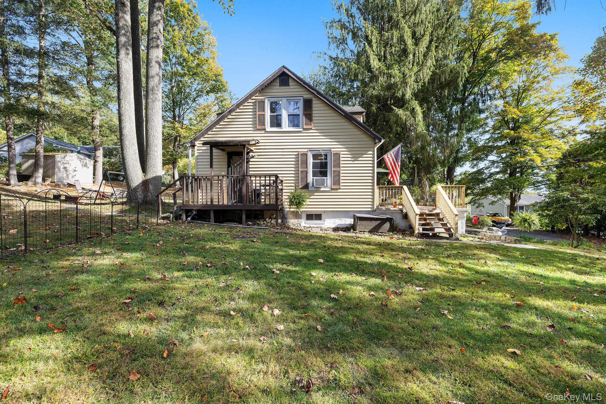 2 Tuxedo Road Carmel, NY 10512 - Photo 4 of 25 a front view of a house with a yard table and chairs