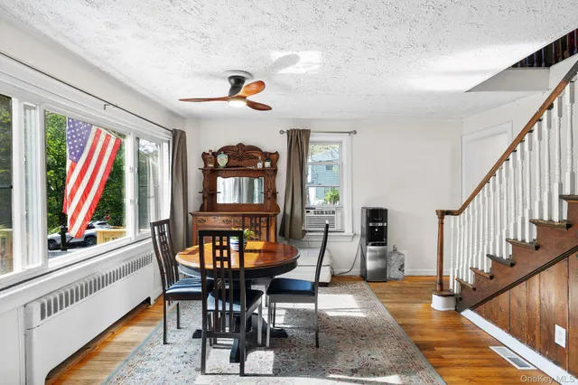 a view of a dining room with furniture window and wooden floor