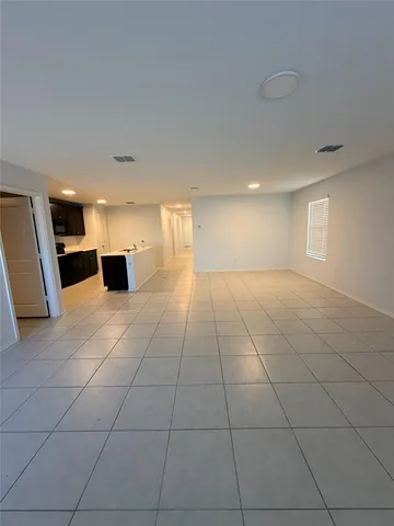 a view of a livingroom with an empty space and a window