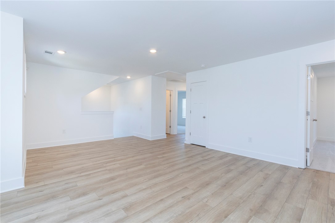 607 WH Kay Lane Anderson, SC 29621 - Photo 22 of 48 Luminous interior with recessed lighting and beautiful light wood flooring.