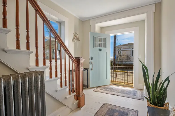 a view of an entryway with wooden floor and door