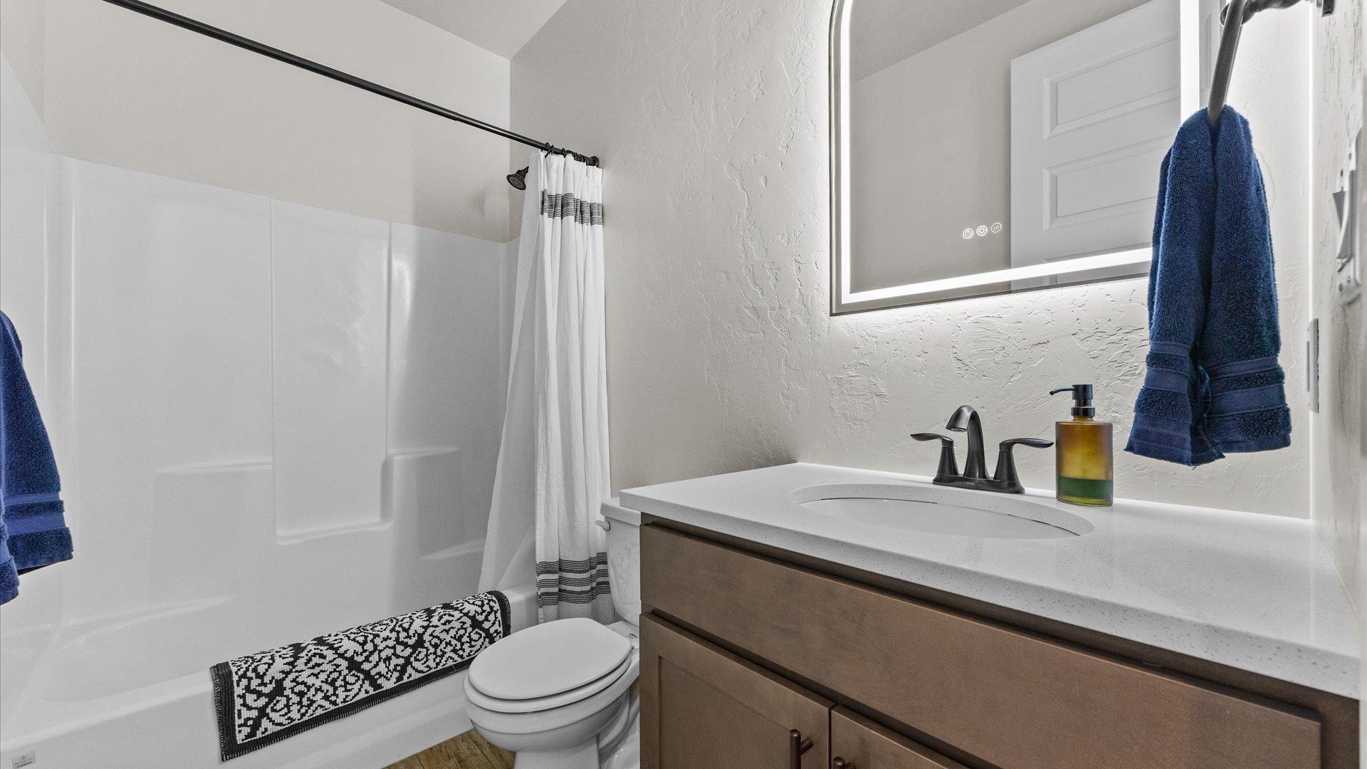 840 Rupp Avenue Palisade, CO 81526 - Photo 23 of 27 a bathroom with a sink a toilet and shower