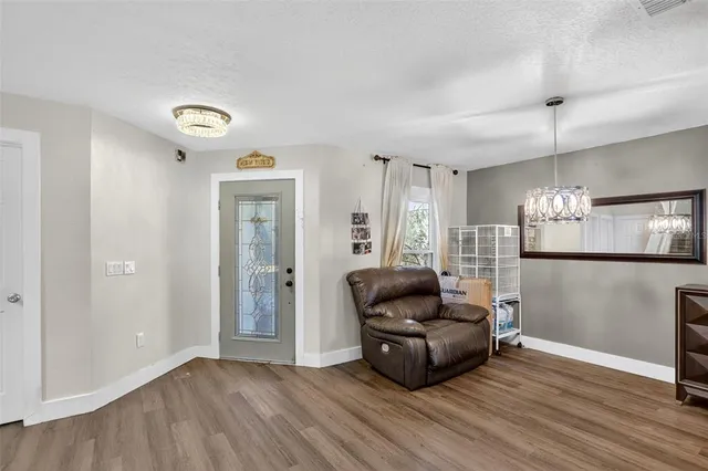 a living room with furniture and a chandelier