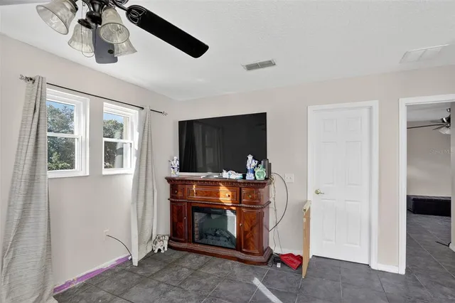a room with chandelier entryway and stairs
