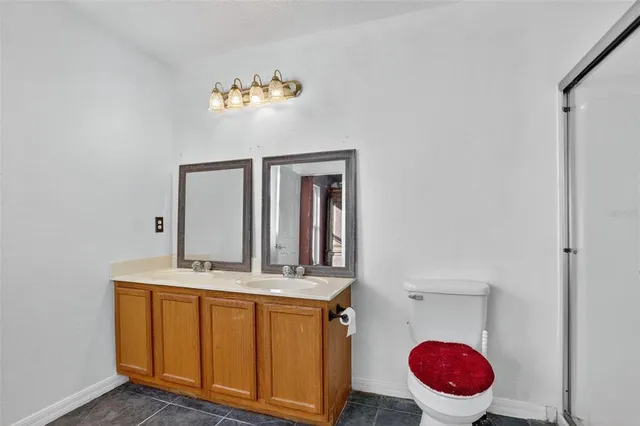 a bathroom with a sink mirror and toilet