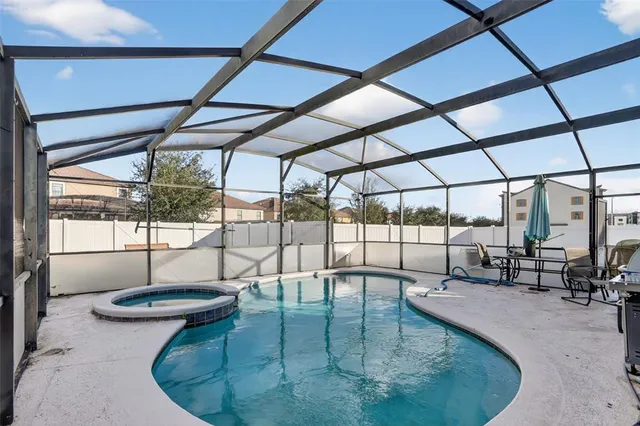 a view of a swimming pool with a patio
