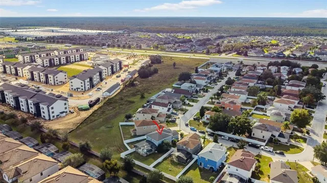 an aerial view of residential houses with outdoor space