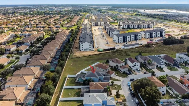 an aerial view of residential building and lake