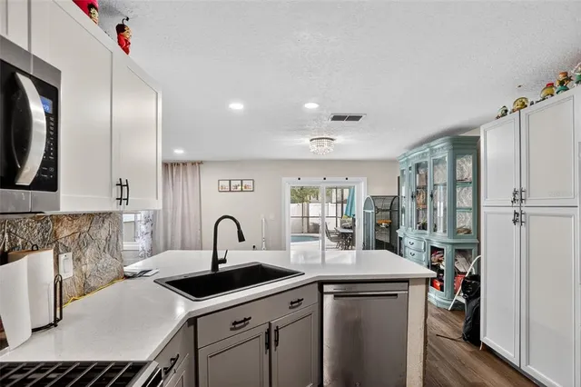 a kitchen with stainless steel appliances a sink stove and refrigerator