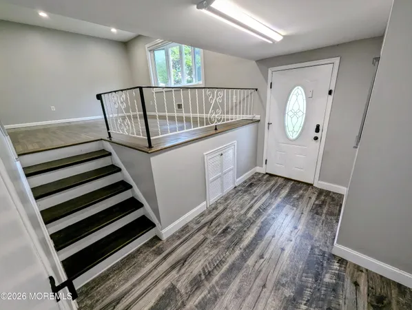 a view of room with window and wooden floor