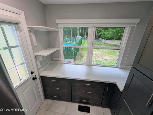 a view of kitchen with furniture and a floor to ceiling window