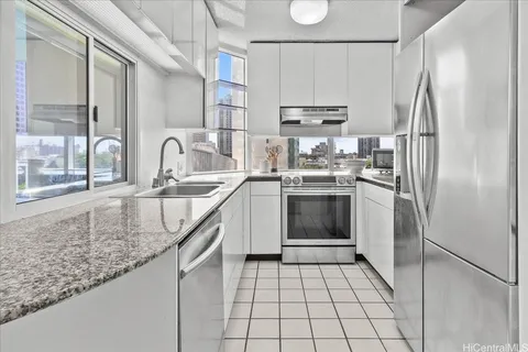 a kitchen with stainless steel appliances granite countertop a sink stove and refrigerator
