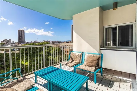a view of a balcony with wooden floor and outdoor seating