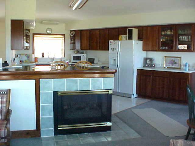 400 Alps Road Moxee, WA 98936 - Photo 6 of 9 a kitchen with stainless steel appliances a stove a refrigerator and a sink with wooden cabinets