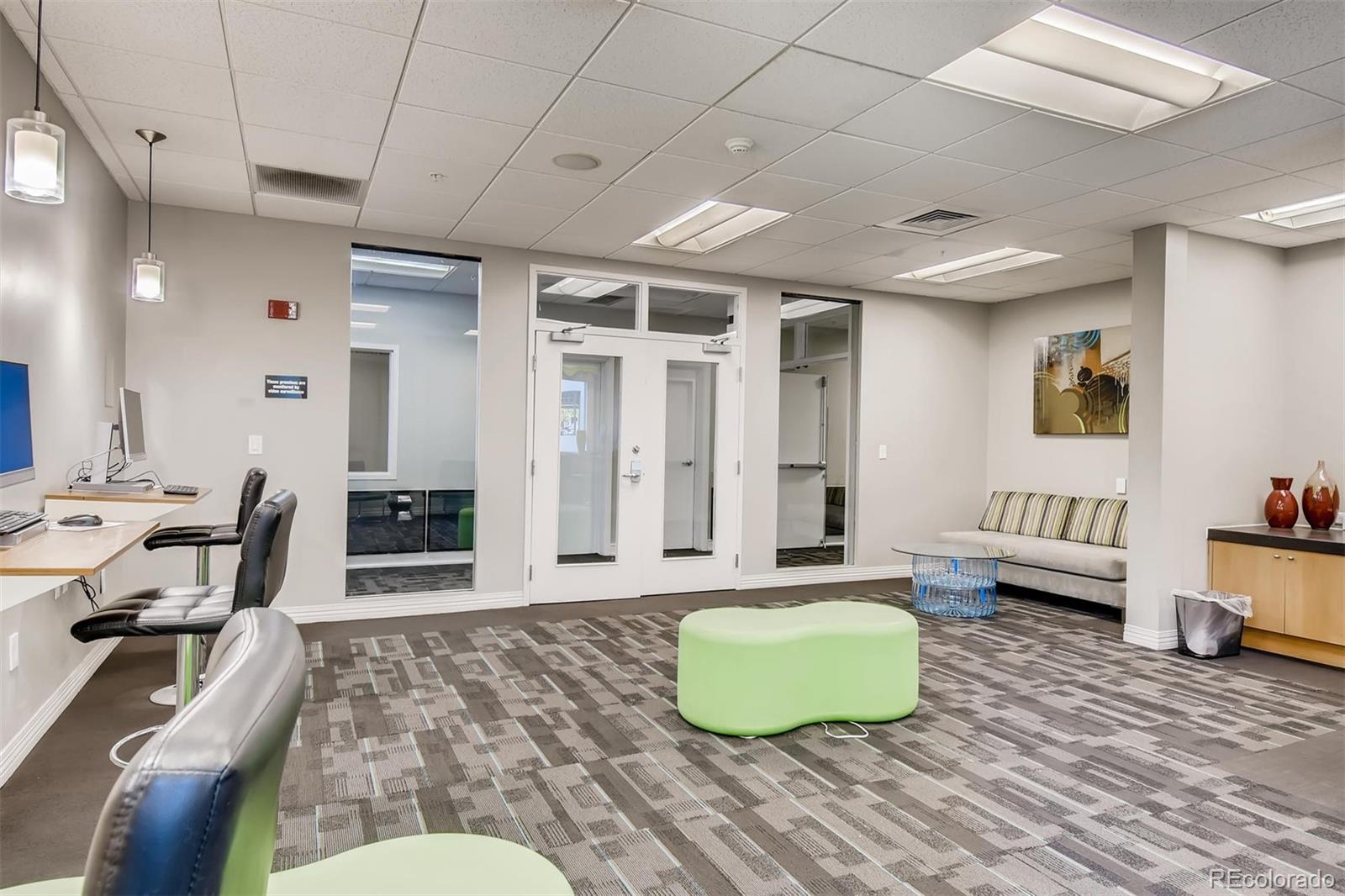 1301 Speer Boulevard, Unit 403 Denver, CO 80204 - Photo 13 of 26 a living room with furniture and wooden floor