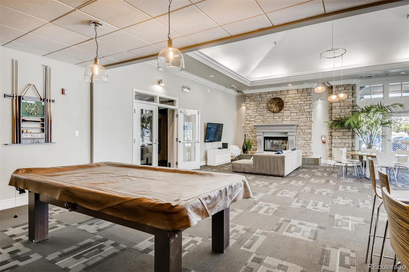 1301 Speer Boulevard, Unit 403 Denver, CO 80204 - Photo 18 of 26 a living room with furniture and a fireplace
