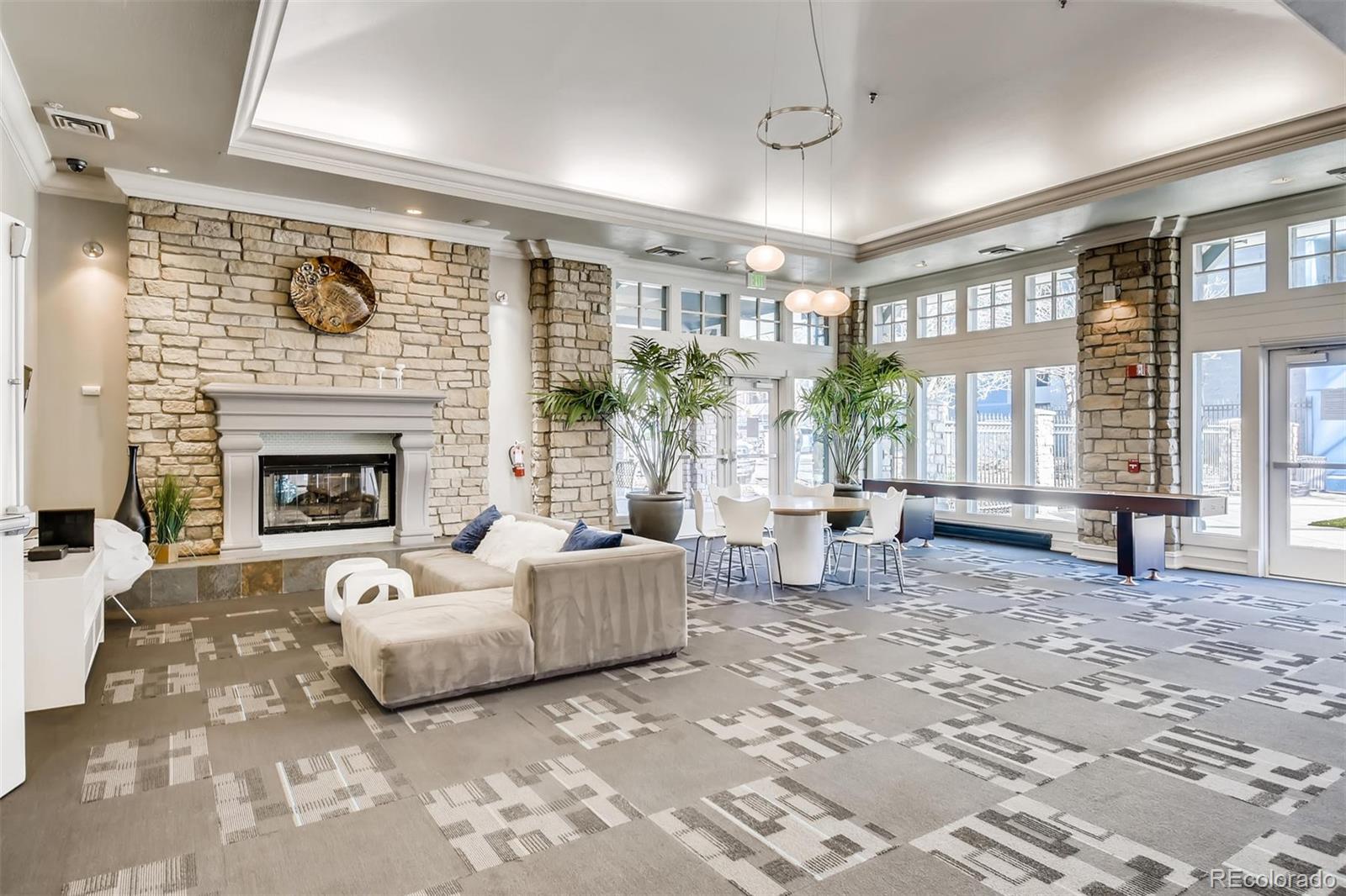 1301 Speer Boulevard, Unit 403 Denver, CO 80204 - Photo 19 of 26 a living room with furniture large window and a fireplace