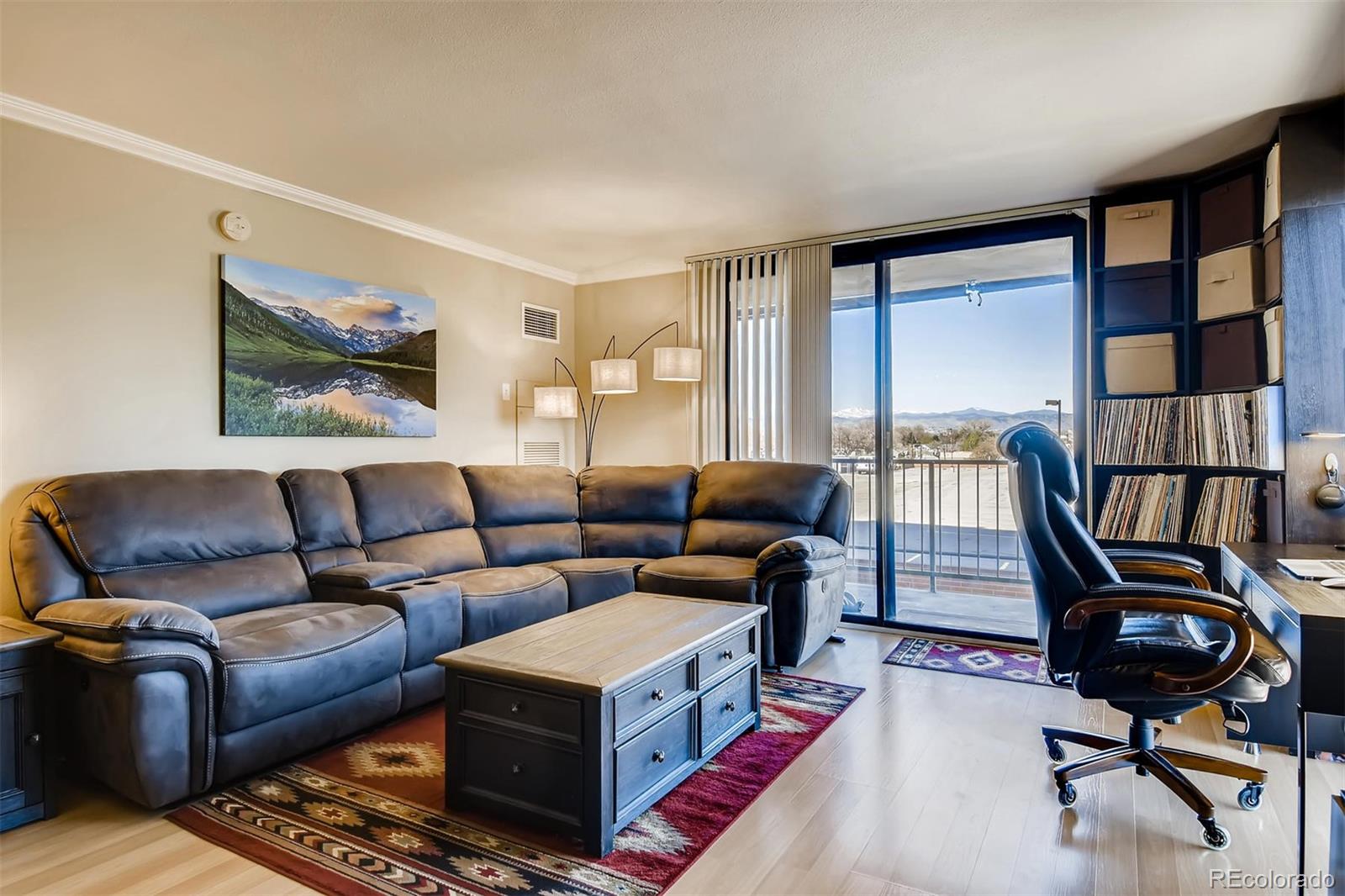 1301 Speer Boulevard, Unit 403 Denver, CO 80204 - Photo 2 of 26 a living room with furniture a rug and a window