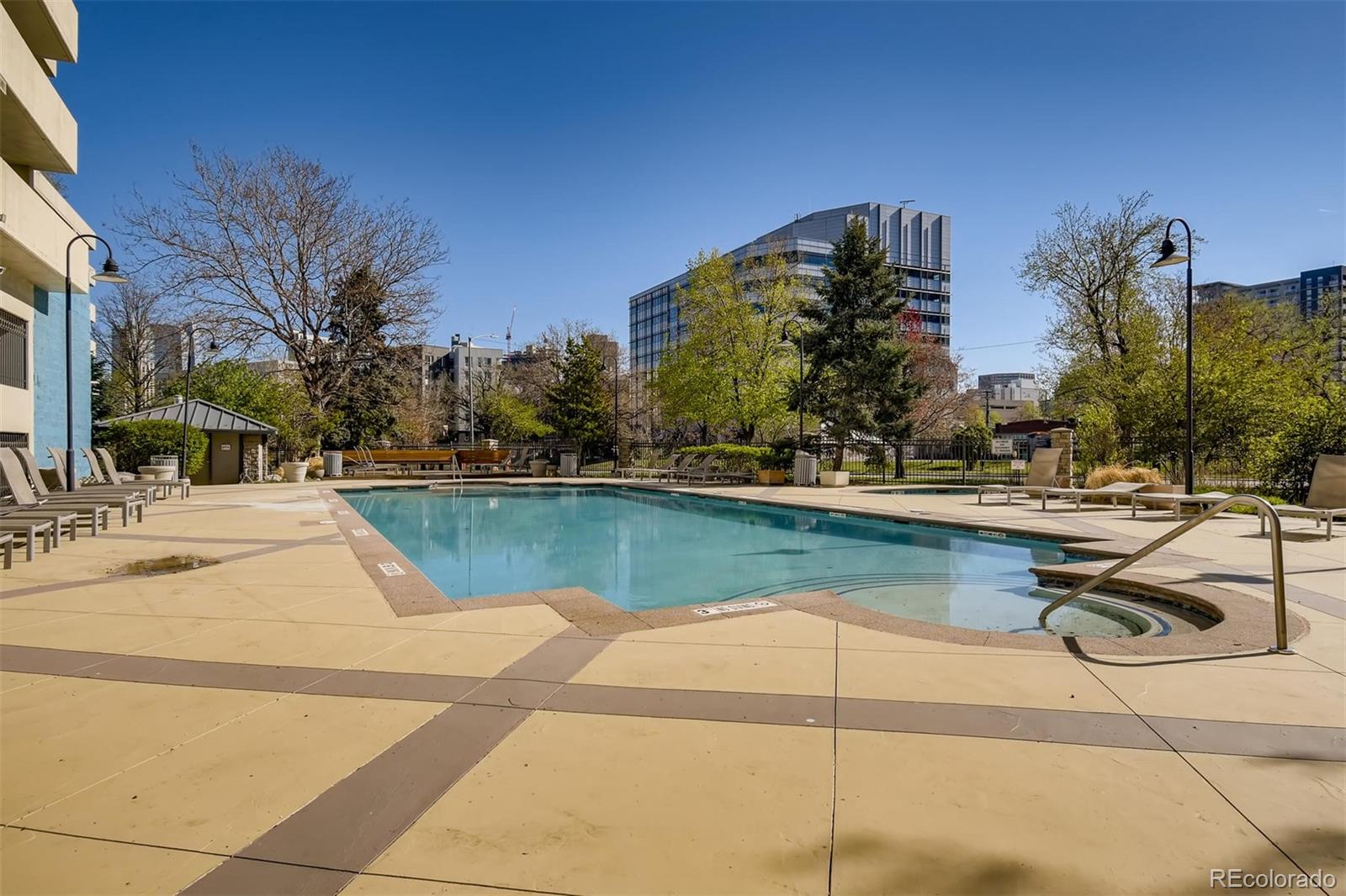 1301 Speer Boulevard, Unit 403 Denver, CO 80204 - Photo 21 of 26 a view of swimming pool with outdoor seating and lake view
