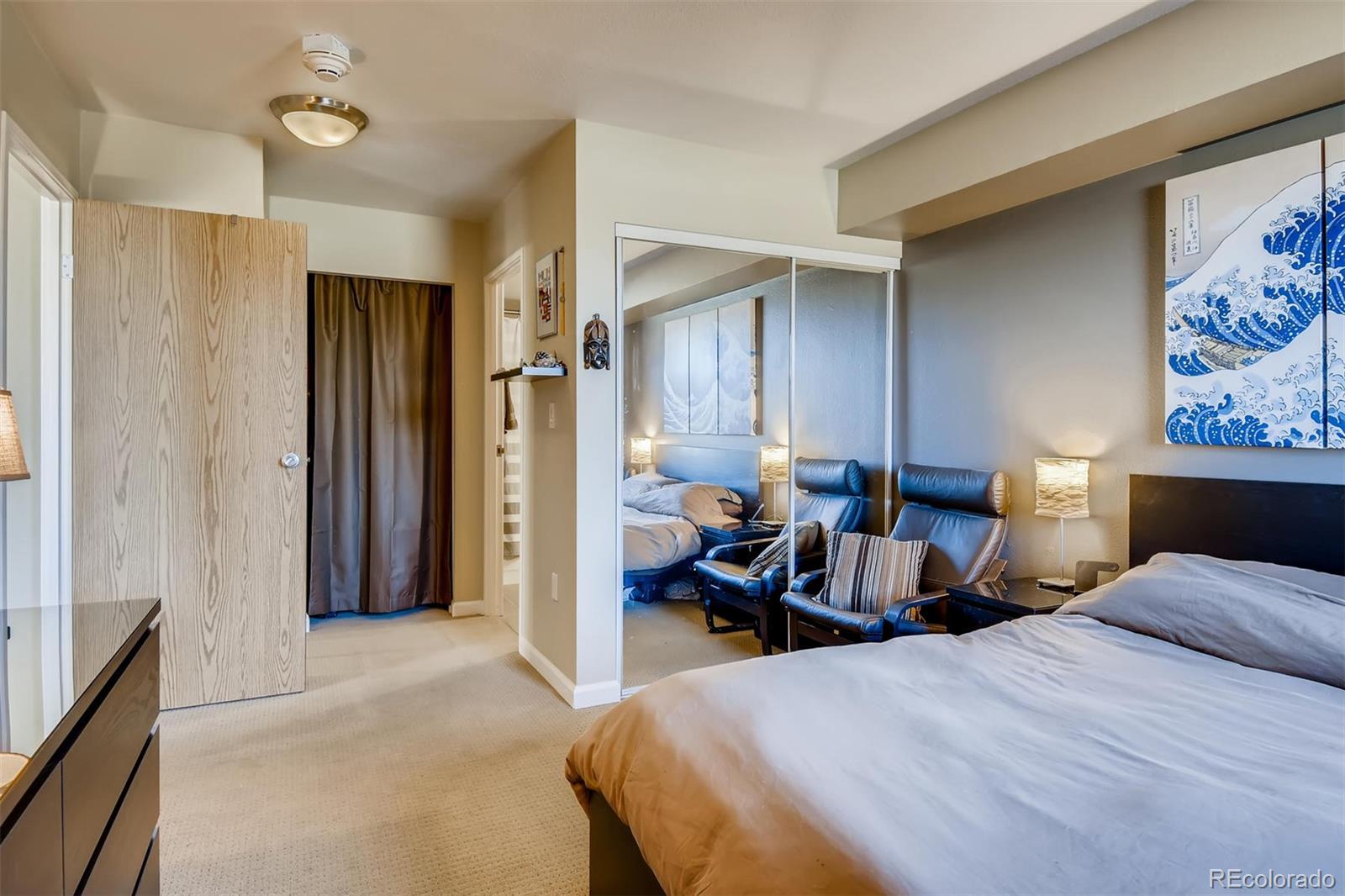 1301 Speer Boulevard, Unit 403 Denver, CO 80204 - Photo 8 of 26 a bed room with a bed and a painting