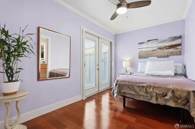 a bedroom with a bed and a potted plant