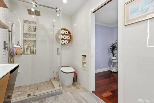 a bathroom with a toilet and a shower