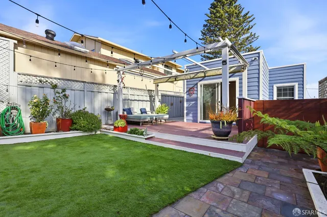 a view of a patio with table and chairs and potted plants