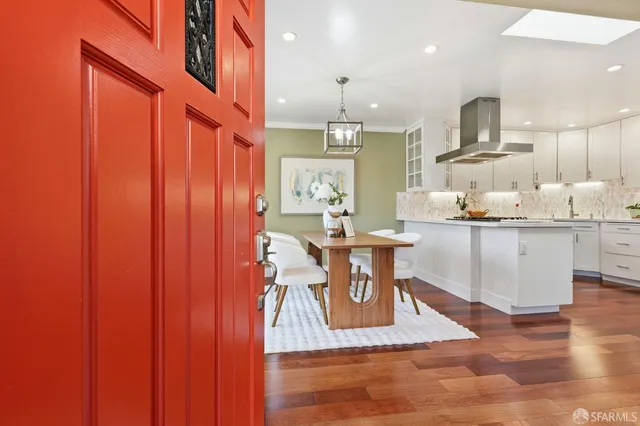 a living room with stainless steel appliances kitchen island granite countertop furniture a rug and a view of kitchen