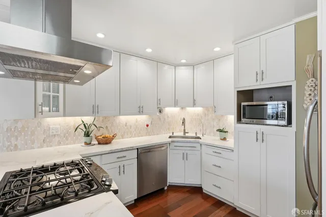 a kitchen with a sink stove and cabinets