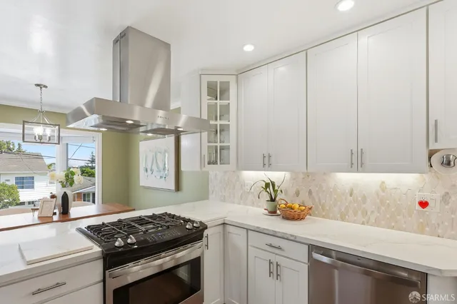 a kitchen with a sink appliances and cabinets
